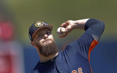 Houston Astros starting pitcher Dallas Keuchel (60) warms up before the start of a spring training baseball game against the Washington Nationals Thursday, March 15, 2018, in West Palm Beach, Fla. (AP Photo/John Bazemore)