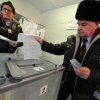 Two men cast their ballots at a polling station in Yelizovo, about 30 kilometers ( 19 miles) north-east from Petropavlovsk-Kamchatsky, capital of Kamchatka Peninsula region, Russian Far East, Russia, on Sunday, March. 18, 2018. Polls have opened in Russia's Far East for the presidential election in which Vladimir Putin seeks a 4th term. (AP Photo/Alexander Petpov)