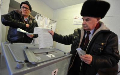 Two men cast their ballots at a polling station in Yelizovo, about 30 kilometers ( 19 miles) north-east from Petropavlovsk-Kamchatsky, capital of Kamchatka Peninsula region, Russian Far East, Russia, on Sunday, March. 18, 2018. Polls have opened in Russia's Far East for the presidential election in which Vladimir Putin seeks a 4th term. (AP Photo/Alexander Petpov)
