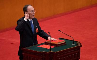Wang Qishan takes the oath of office after being elected as vice president during a plenary session of China's National People's Congress at the Great Hall of the People in Beijing, Saturday, March 17, 2018. Xi Jinping was reappointed Saturday as China's president with no limit on the number of terms he can serve. The National People's Congress, China's rubber-stamp legislature, also appointed close Xi ally Wang Qishan to the formerly ceremonial post of vice president. (AP Photo/Andy Wong)