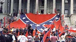 BIGOTS’ JAMBOREE Defenders of the stars-and-bars emblem of white racism rally on the steps of the South Carolina statehouse.