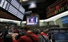 Traders at CME Group watch a television broadcast of Federal Reserve Chairman Bernanke in Chicago, April 27, 2011. REUTERS Frank Polich