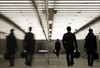 Businessmen with briefcases walking through an office complex. REUTERS Yuriko Nakao