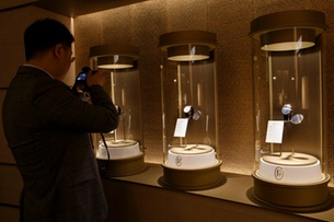 A journalist takes a picture of a watch