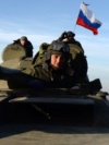 A Russian flag flies above a tank manned by separatists near the front line in eastern Ukraine. 